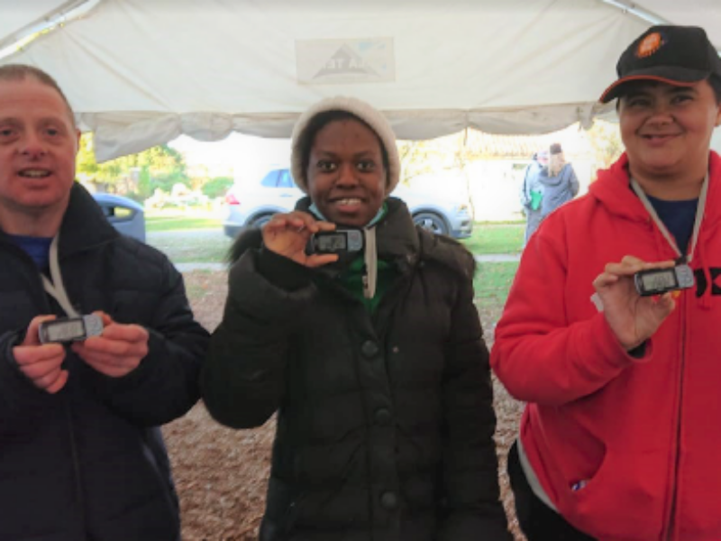 Three students at Share show off their pedometers