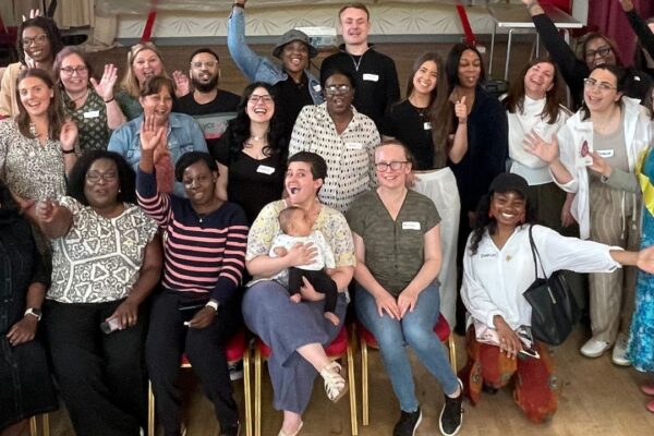 Group shot of cheering people who took part in the Whose Shoes? board game event at St George's Hospital